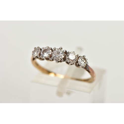 82 - A YELLOW METAL FIVE STONE DIAMOND RING, set with four old cut diamonds and one round brilliant cut d... 