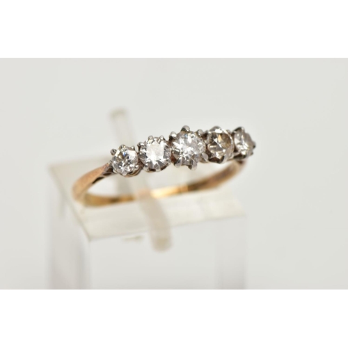 82 - A YELLOW METAL FIVE STONE DIAMOND RING, set with four old cut diamonds and one round brilliant cut d... 