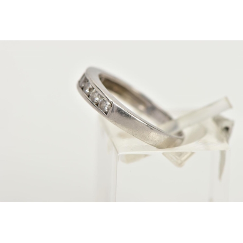 85 - A PLATINUM DIAMOND HALF ETERNITY RING, designed with a row of channel set round brilliant cut diamon... 