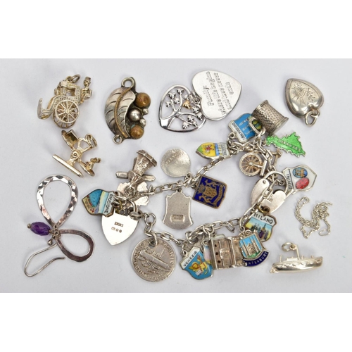 89 - A CHARM BRACELET, LOOSE CHARMS AND PENDANTS, the charm bracelet fitted with various enamel shield ch... 