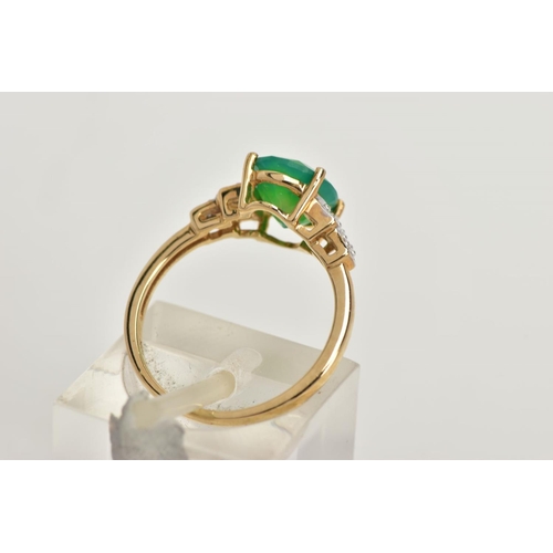 95 - A 9CT GOLD GEM SET RING, designed with a four claw set oval cut green stone, flanked with stepped sh... 