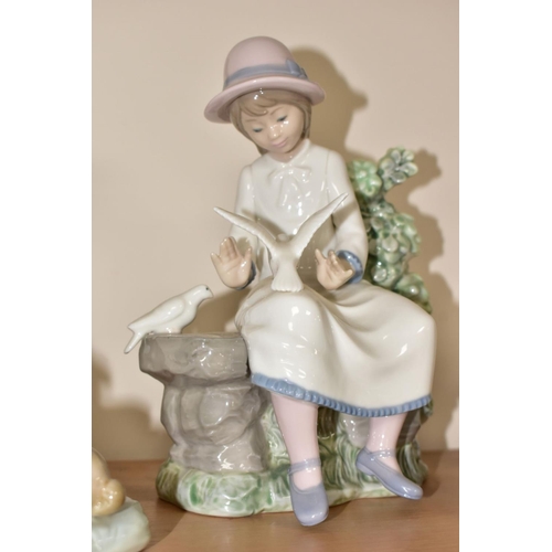 467 - A LLADRO FIGURE AND TWO NAO FIGURES, comprising a Lladro 'Food for Ducks, no.4849, sculpted by Anton... 