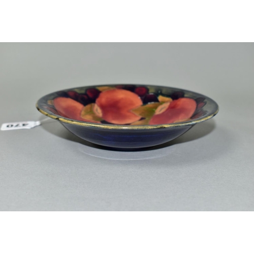 470 - A MOORCROFT POTTERY SHALLOW CIRCULAR BOWL DECORATED IN THE POMEGRANATE PATTERN ON A MOTTLED BLUE GRO... 