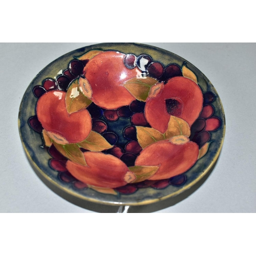 470 - A MOORCROFT POTTERY SHALLOW CIRCULAR BOWL DECORATED IN THE POMEGRANATE PATTERN ON A MOTTLED BLUE GRO... 