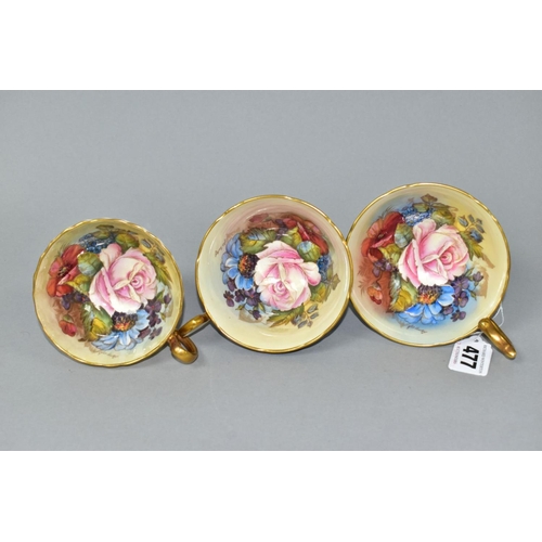 477 - THREE AYNSLEY CABBAGE ROSE TEA CUPS DECORATED BY J.A. BAILEY, comprising pattern no. 1028 with solid... 