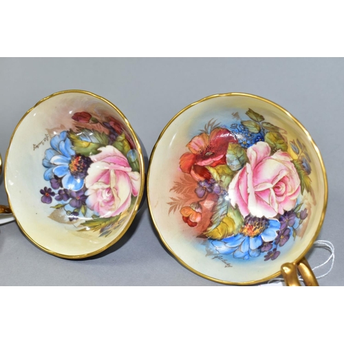 477 - THREE AYNSLEY CABBAGE ROSE TEA CUPS DECORATED BY J.A. BAILEY, comprising pattern no. 1028 with solid... 