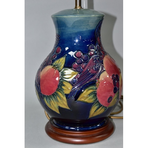 508 - A MOORCROFT POTTERY BALUSTER TABLE LAMP DECORATED WITH FINCHES AND FRUIT, blue green ground, mounted... 