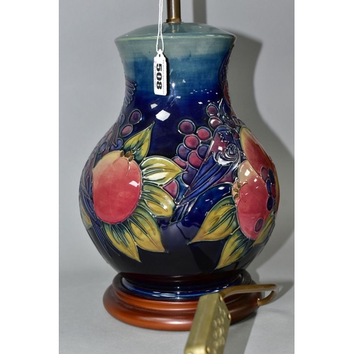 508 - A MOORCROFT POTTERY BALUSTER TABLE LAMP DECORATED WITH FINCHES AND FRUIT, blue green ground, mounted... 