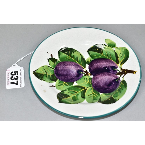 537 - A WEMYSS TEA PLATE PAINTED WITH PURPLE PLUMS ON A SECTION OF BRANCH, retailed by T. Goode & Co, prin... 