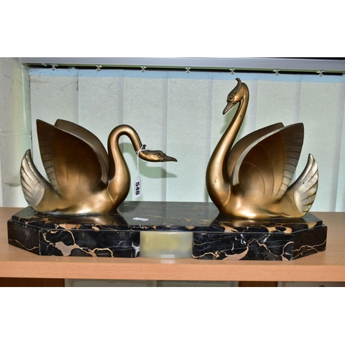 548 - AN ART DECO STYLE SCULPTURE OF TWO GILT METAL SWANS ON A SHAPED RECTANGULAR MARBLE PLINTH, after Mou... 