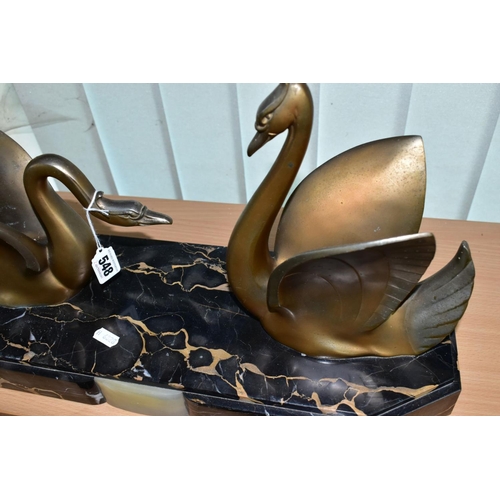 548 - AN ART DECO STYLE SCULPTURE OF TWO GILT METAL SWANS ON A SHAPED RECTANGULAR MARBLE PLINTH, after Mou... 