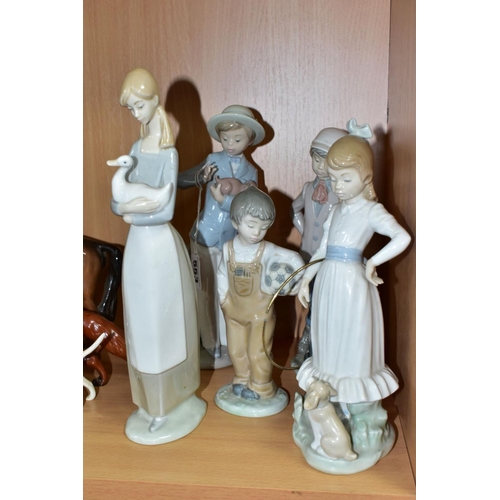 553 - FIVE NAO PORCELAIN FIGURINES, comprising a girl with a hoop, two children with puppies, a boy with a... 