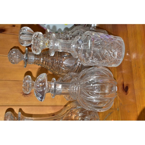 568 - EIGHT DECANTERS AND OTHER PIECES OF CUT GLASS, to include a French sectional decanter (missing stopp... 