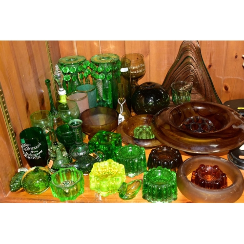 570 - A GROUP OF GREEN, BROWN AND URANIUM GLASSWARES, to include pressed glass furniture rests/piano insul... 