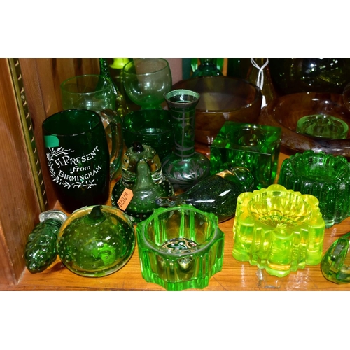 570 - A GROUP OF GREEN, BROWN AND URANIUM GLASSWARES, to include pressed glass furniture rests/piano insul... 