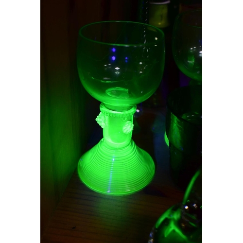 570 - A GROUP OF GREEN, BROWN AND URANIUM GLASSWARES, to include pressed glass furniture rests/piano insul... 