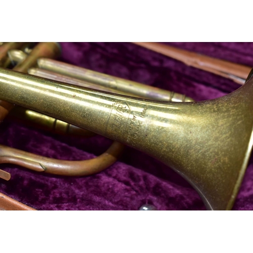 582 - A CASED LAFLEUR BRASS CORNET Serial No 658000 (brass is tarnished, one valve doesn't return and spit... 