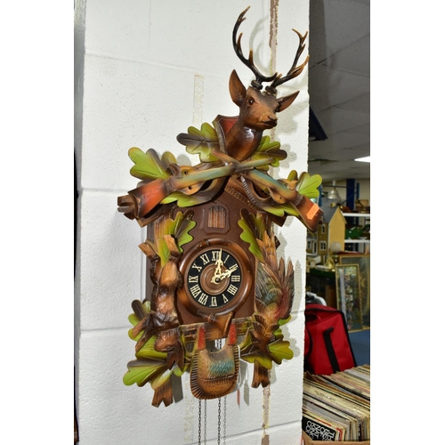 591 - A LATE 20TH CENTURY GERMAN CUCKOO CLOCK, with pendulum and weights, movement in need of restoration,... 