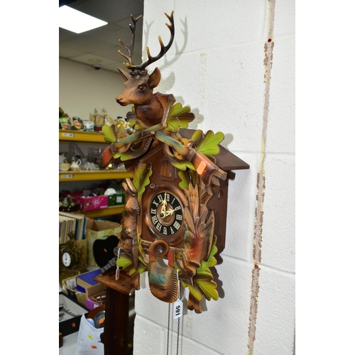 591 - A LATE 20TH CENTURY GERMAN CUCKOO CLOCK, with pendulum and weights, movement in need of restoration,... 