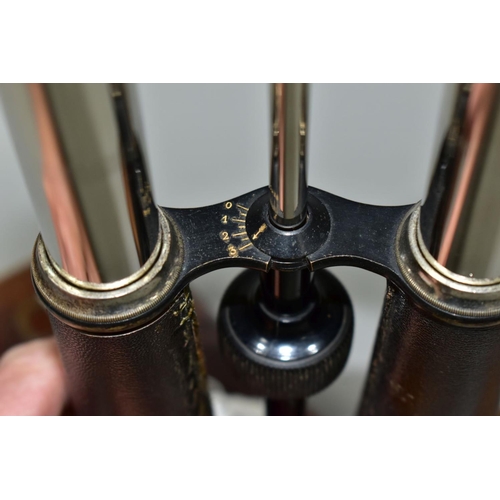 597 - A PAIR OF 14X MAGNIFICATION BINOCULARS BY LLOYD OPTICIAN OF BOSTON, the leather to one barrel has be... 