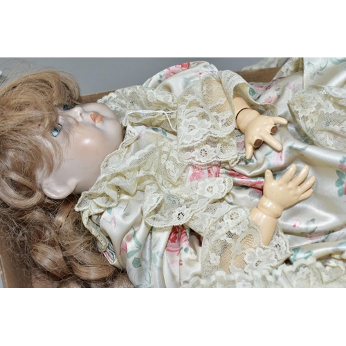 600 - A MODERN BISQUE HEAD DOLL, nape of neck marked '70', fixed blue glass eyes, painted lashes, closed m... 