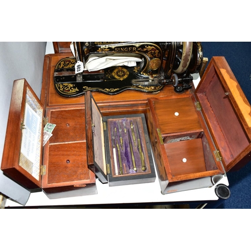 603 - A LATE VICTORIAN SINGER SEWING MACHINE, complete with wooden case, together with drawing instruments... 