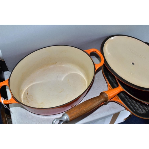 647 - THREE PIECES OF LE CREUSET AND SIMILAR CAST IRON COOKWARES, comprising a Le Creuset oval casserole i... 