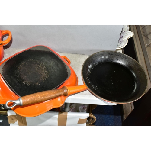 647 - THREE PIECES OF LE CREUSET AND SIMILAR CAST IRON COOKWARES, comprising a Le Creuset oval casserole i... 