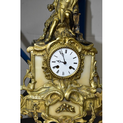 687 - AN EARLY 20TH CENTURY SPECKLED GREY MARBLE AND GILT METAL MANTEL CLOCK, urn surmount, foliate side h... 