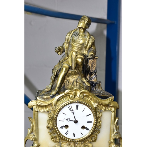 687 - AN EARLY 20TH CENTURY SPECKLED GREY MARBLE AND GILT METAL MANTEL CLOCK, urn surmount, foliate side h... 