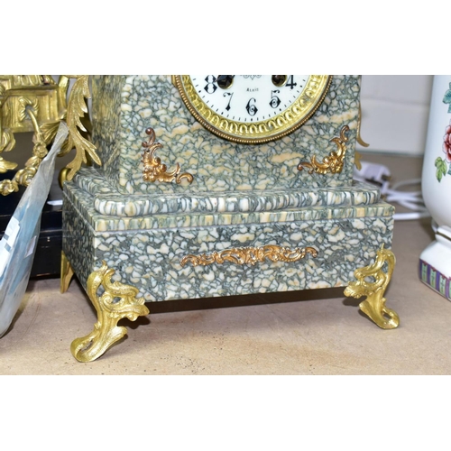 687 - AN EARLY 20TH CENTURY SPECKLED GREY MARBLE AND GILT METAL MANTEL CLOCK, urn surmount, foliate side h... 