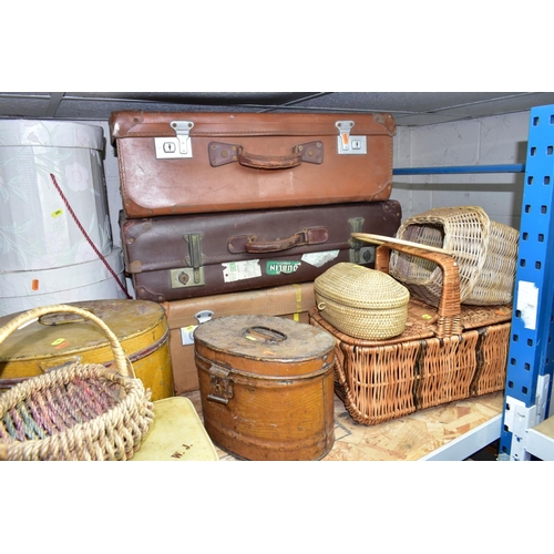 694 - A QUANTITY OF VINTAGE LUGGAGE, BASKETS, ETC, to include four brown vintage suitcases, most with trav... 