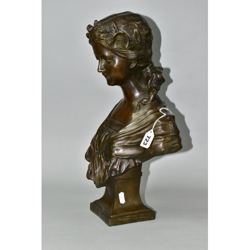 723 - A PATINATED BRONZE BUST, young female with head bowed, garlands in hair and tied shawl over shoulder... 