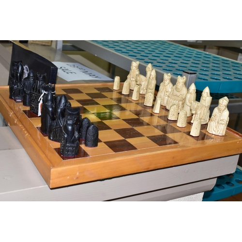 747 - AN ISLE OF LEWIS STYLE CHESS SET, with wooden board 49.5cm square, cast resin cream and black pieces... 