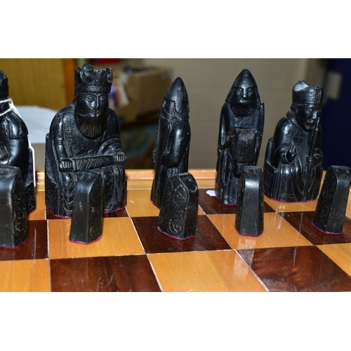 747 - AN ISLE OF LEWIS STYLE CHESS SET, with wooden board 49.5cm square, cast resin cream and black pieces... 