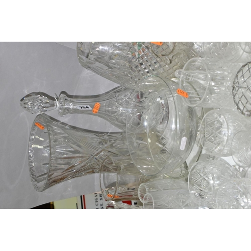 754 - A QUANTITY OF CUT CRYSTAL AND OTHER GLASSWARES, to include three decanters, three large vases talles... 