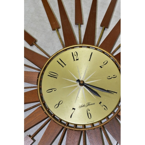 770 - A SETH THOMAS OF SCOTLAND TEAK SUNBURST WALL CLOCK, Arabic numerals, missing one of the metal and wo... 