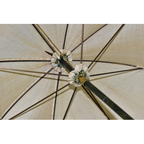 778 - AN EDWARDIAN SILK PARASOL, cream silk canopy and green stained wooden shaft, approximate length 92cm... 