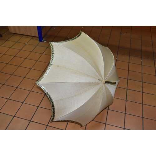 778 - AN EDWARDIAN SILK PARASOL, cream silk canopy and green stained wooden shaft, approximate length 92cm... 