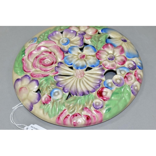 785 - A CLARICE CLIFF WILKINSON LTD CIRCULAR BOUQUET WALL PLAQUE, relief moulded with pastel colour flower... 