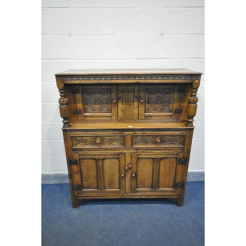 1382 - A MID CENTURY REPRODUCTION SOLID CARVED OAK COURT CUPBOARD, top with two cupboard doors, with twin a... 