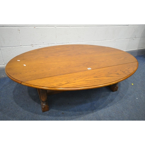 1389 - AN OAK DROP LEAF OVAL COFFEE TABLE, on turned legs and block feet, united by stretchers, length 139c... 