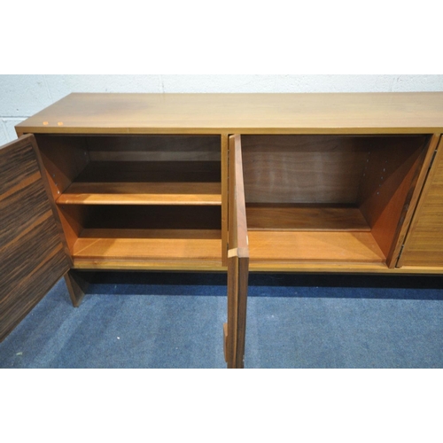 1391 - A MID CENTURY DANISH STYLE WALNUT SIDEBOARD, with three cupboard doors, right door enclosing two dra... 