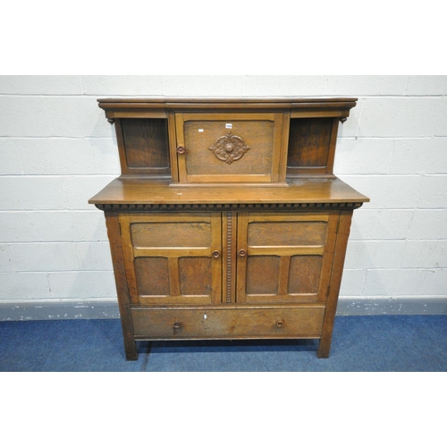 1395 - AN OAK COURT CUPBOARD, with an arrangement of cupboard doors over a single long drawer, width 137cm ... 