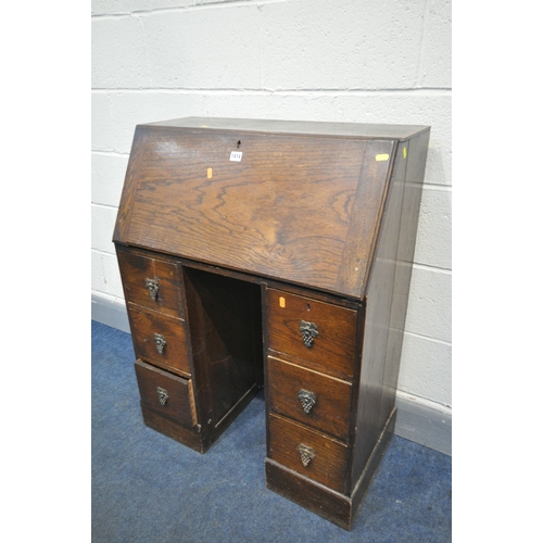 1400 - AN EARLY 20TH CENTURY OAK SLIM LADIES BUREAU, fall front door enclosing a fitted interior, with two ... 