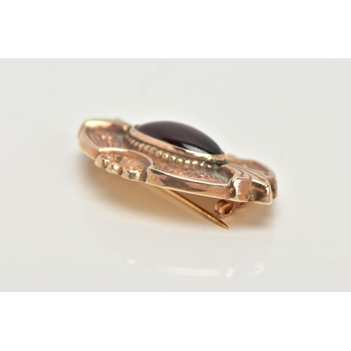 16 - A 9CT GOLD GARNET BROOCH, a rose gold Victorian style brooch, set with an elongated oval garnet, det... 