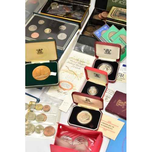 186 - A CARDBOARD BOX OF MIXED COINS AND YEAR SETS, to include five UK royal mint proof year sets 1983,198... 