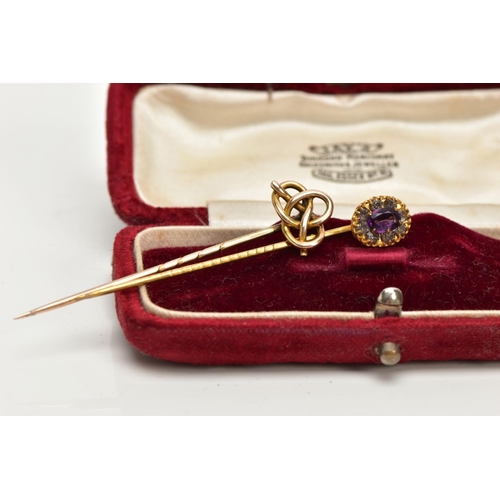 196 - TWO YELLOW METAL STICK PINS, the first detailed with an oval cluster, centring on an oval cut amethy... 