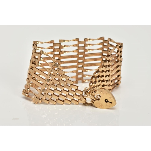 2 - A 9CT GOLD GATE BRACELET, nine row gate bracelet, comprising of six twisted bars and three straight ... 