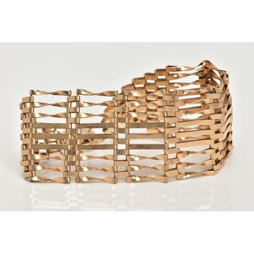 2 - A 9CT GOLD GATE BRACELET, nine row gate bracelet, comprising of six twisted bars and three straight ... 